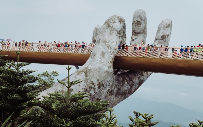 Golden Bridge held by giant stone hands at Bana Hills, Da Nang, Vietnam