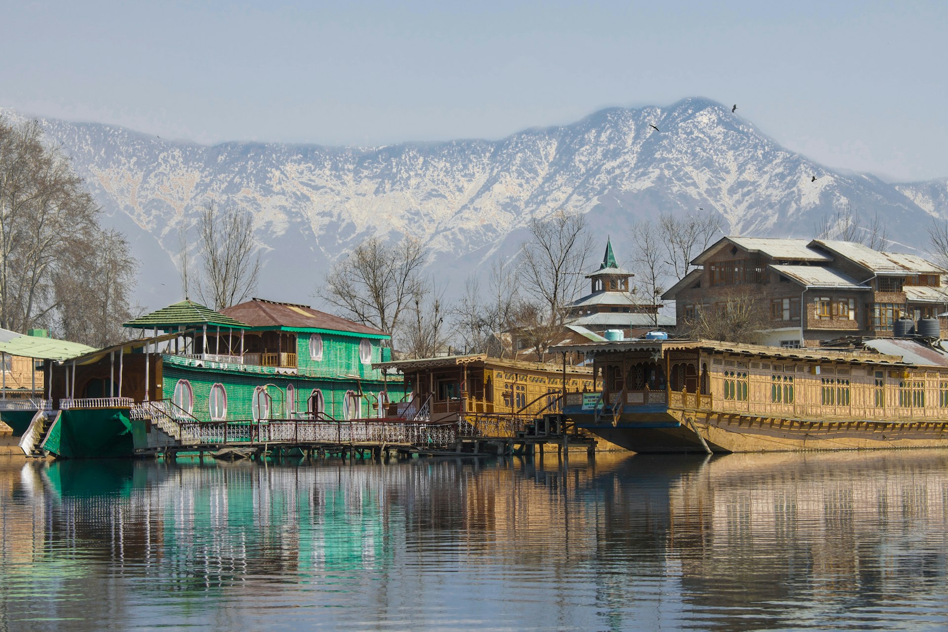 Dal Lake shikara boats and mountains in Srinagar, Kashmir, Surat to Kashmir tour packages