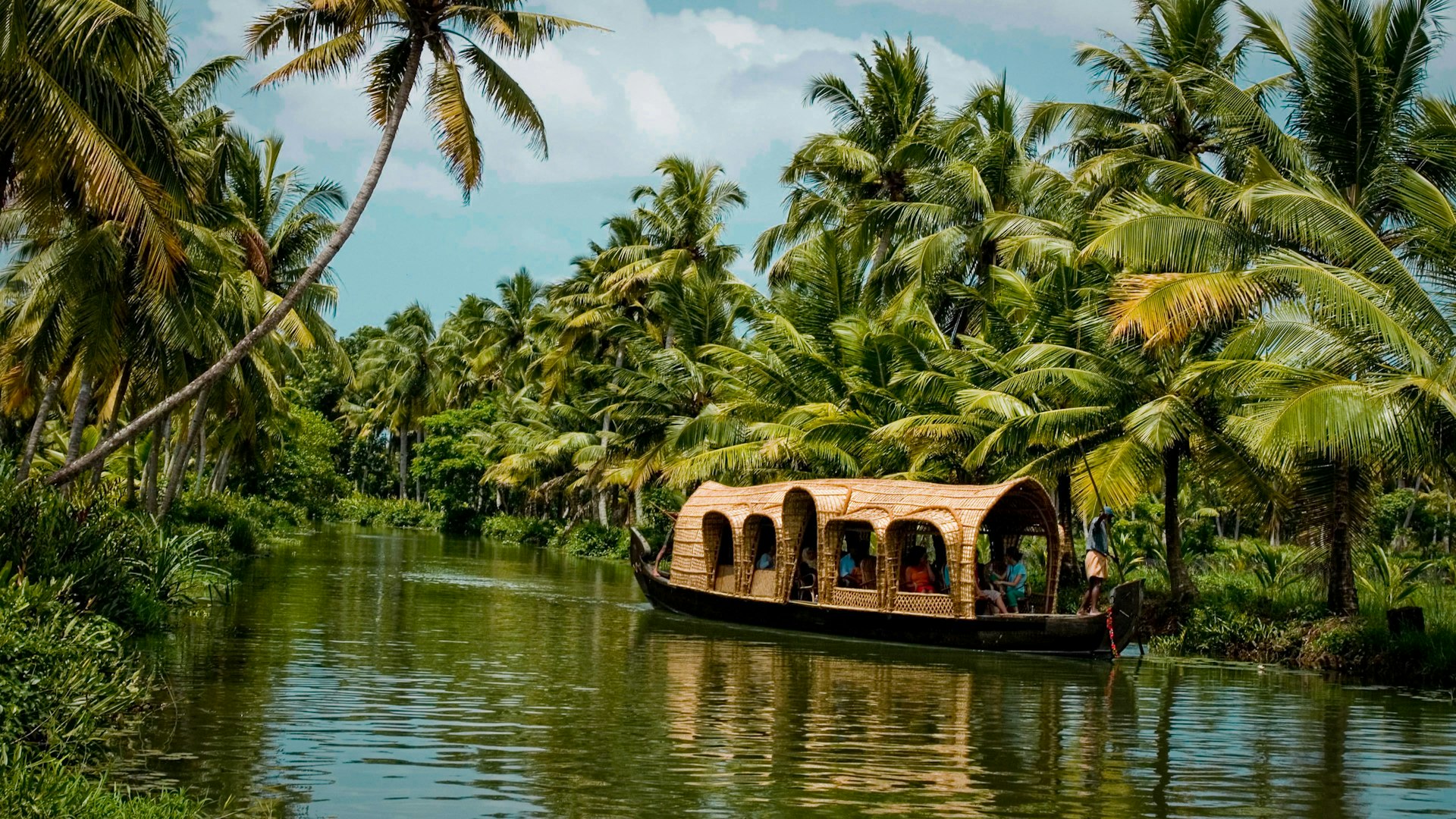 Alleppey backwaters with a traditional houseboat in Kerala, Surat to Kerala tour packages